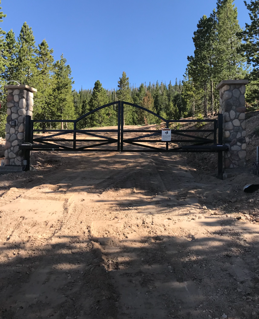 Custom gate entrance on a dirt road